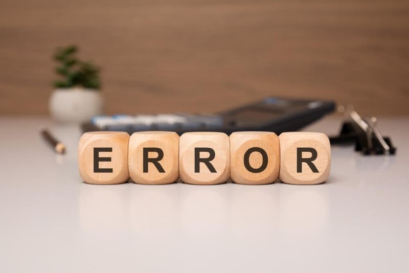 Text error on wooden blocks on a table