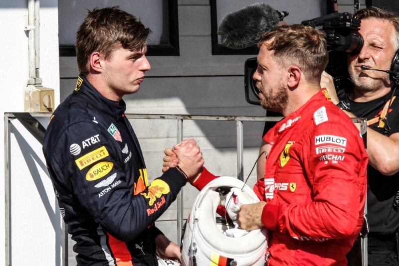 Two F1 car racers shaking hands before competing