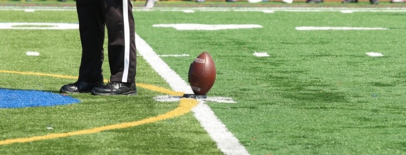 Football returner taking a touchback in the end zone