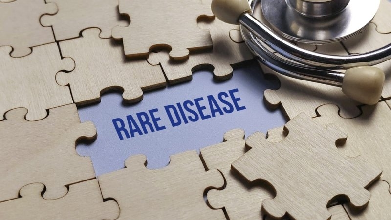 Missing puzzle piece revealing rare disease text with stethoscope for complex medical diagnosis concept.