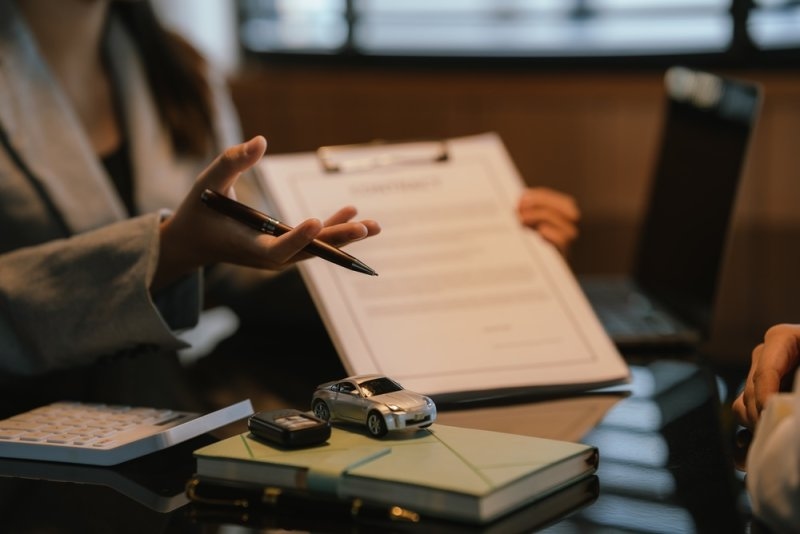 Agent explaining about car insurance through papers