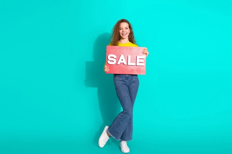 girl holding sale tag in her hand