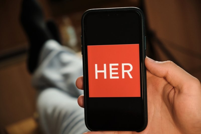 HER dating application logo on a phone screen