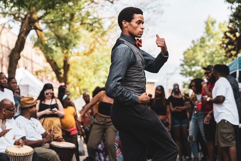 man performing hip hop dance in streets