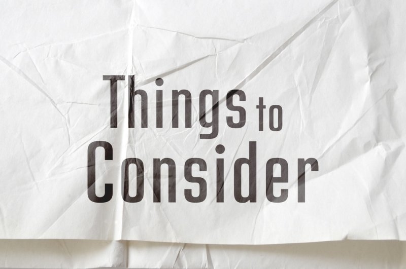 Text reading “Things to Consider” on a crumpled white paper background.