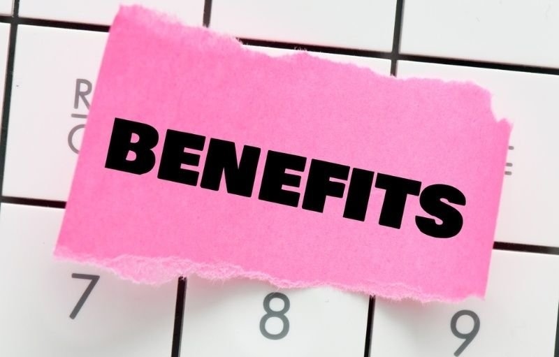 BENEFITS word on a small piece of paper lying on the calculator.