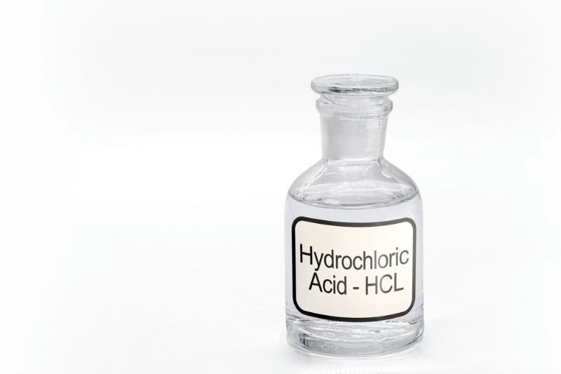 A glass bottle labeled as hypochlorous acid-HCL.