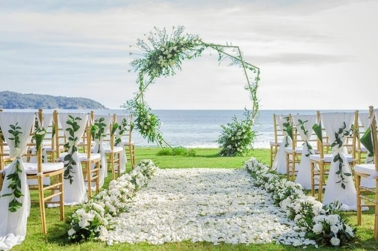 a beautifully decorated weeding venue with white flowers featuring natural wedding color scheme-Bridalfusion