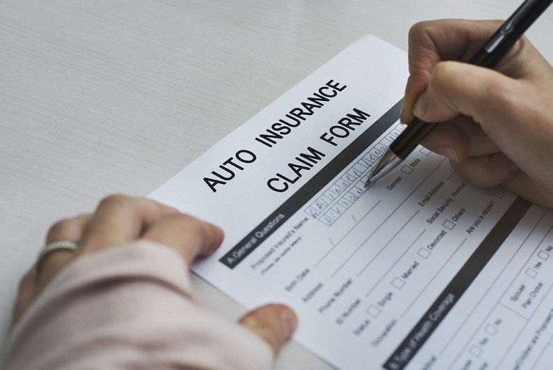 auto insurance claim form being filled