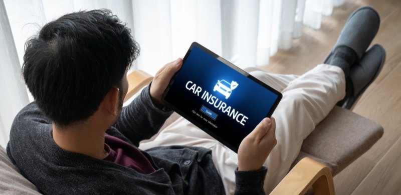 man looking for affordable car insurance quotes on his tablet