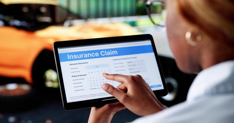 Man purchasing car insurance online using his tablet