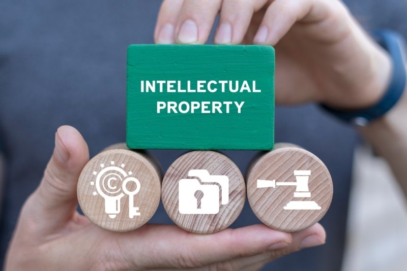 Man holding wooden blocks sees intellectual property law