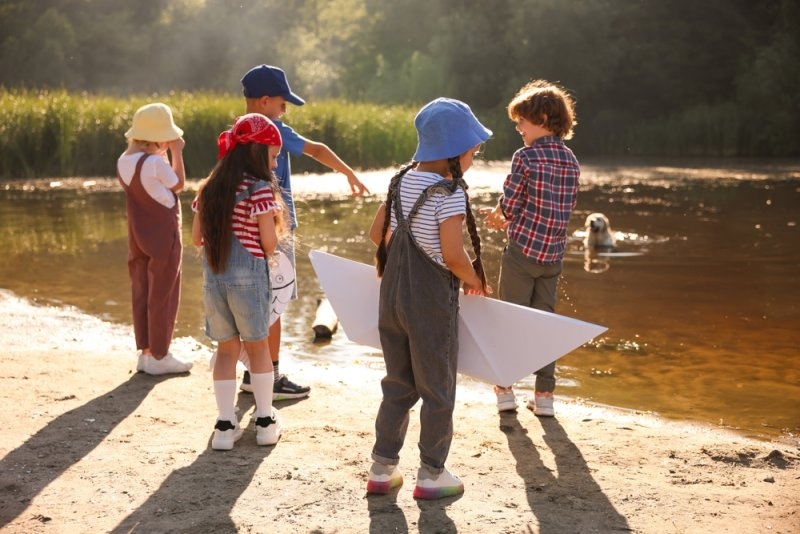 Children spending time by lake in nature