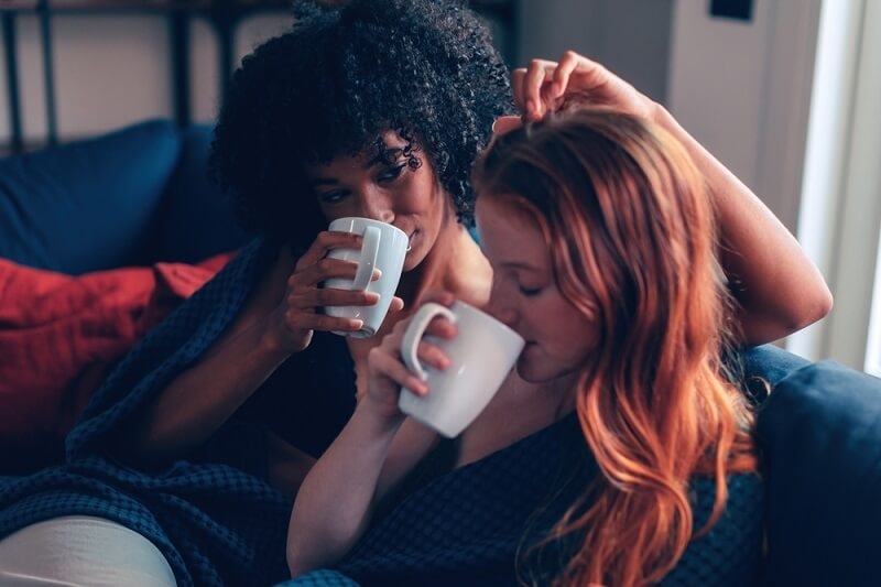 lesbian couple sitting and drinking tea