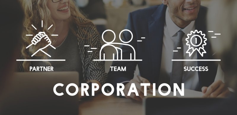 Business professionals meeting at a table with overlay icons representing partnership, teamwork, and success, alongside the word