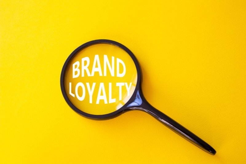 text Brand Loyalty under a magnifying glass