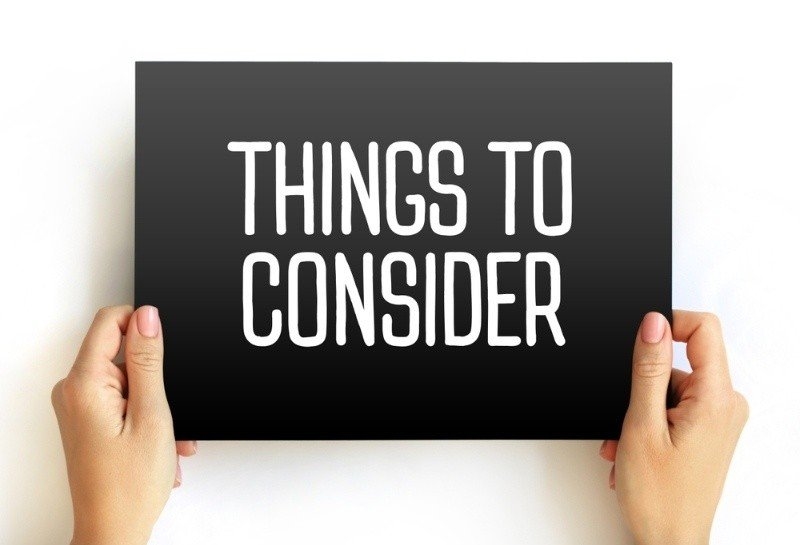 “Things To Consider” text on a black card and 2 hands holding it.