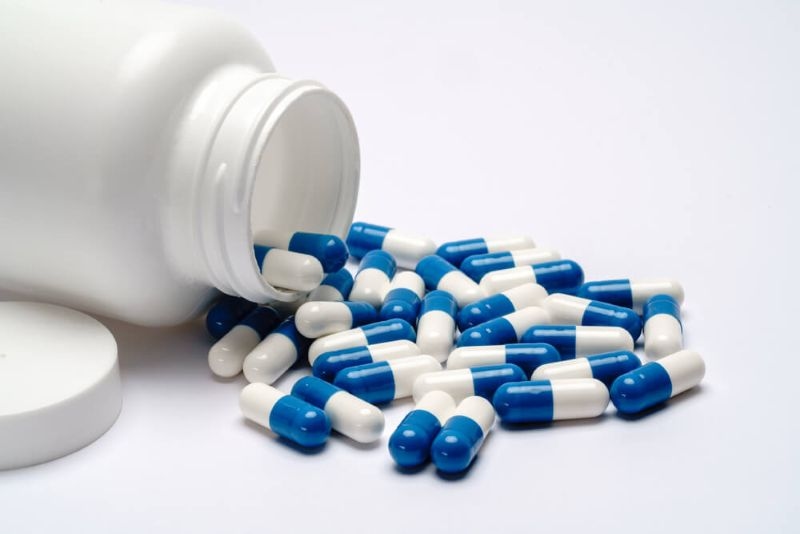 medical capsules flowing out of the box