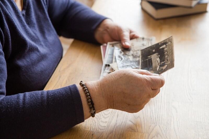 old woman watching old childhood memories pictures