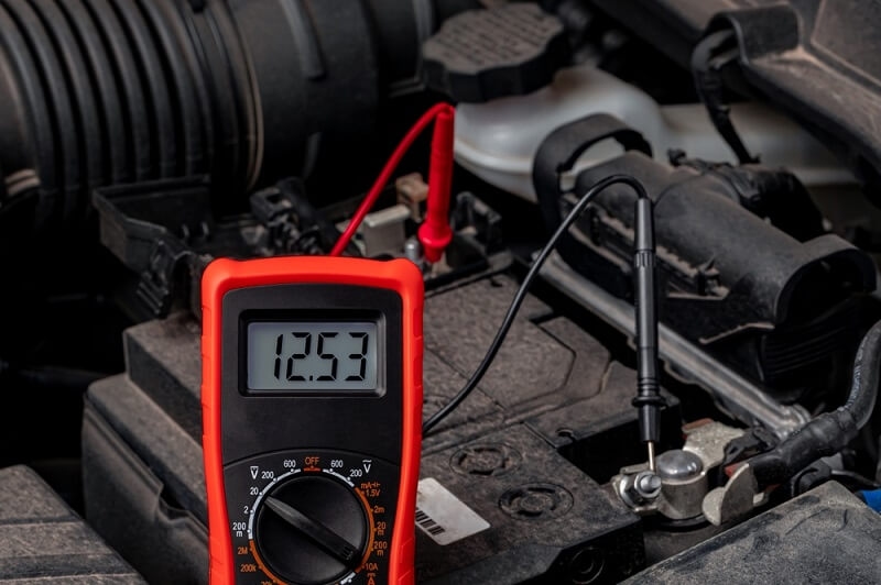 man checking battery condition thorugh meter
