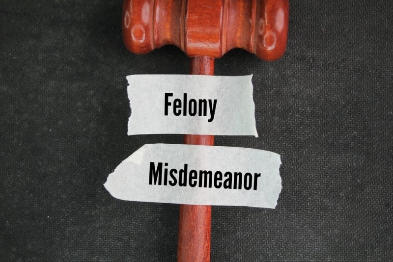 judge's hammer and stickers with the words felony and misdemeanor.