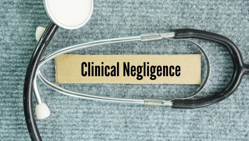 Stethoscope surrounding a label reading “Clinical Negligence.”