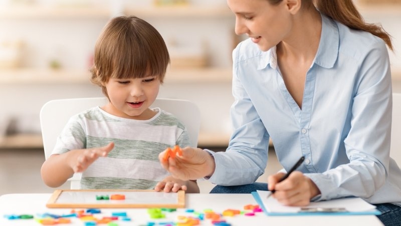 Child Learns With Mother Using Colorful Building Blocks