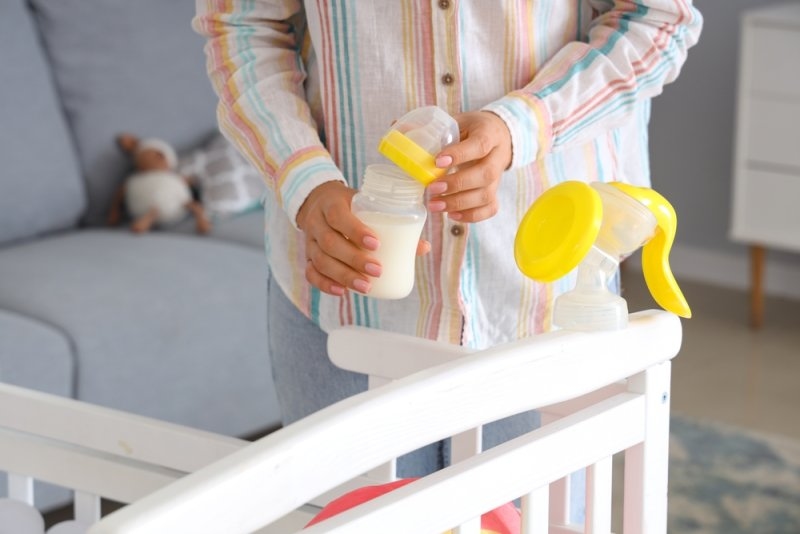 Mother using a breast pump to express breast milk