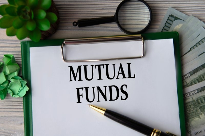 Mutual funds text printed on a paper clipped to a board