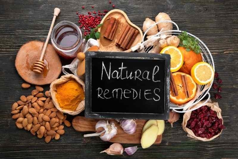 A chalkboard labeled “Natural Remedies” surrounded by natural ingredients.