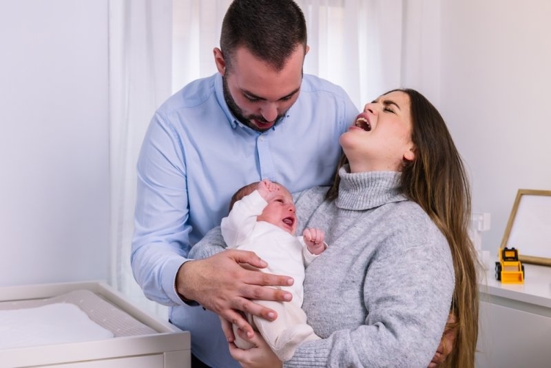 Parents experiencing stress and despair with crying new-born