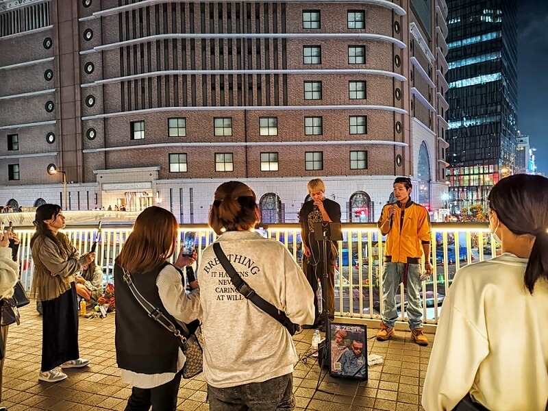 people enjoying nightlife street show