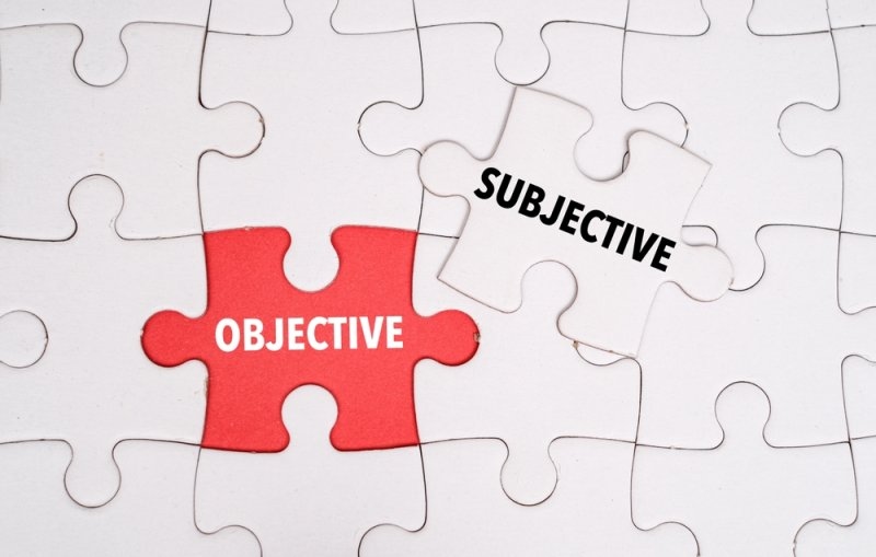 Puzzle pieces illustrating the difference between objective and subjective concepts.