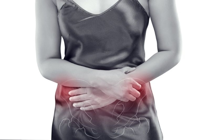 Woman holding her lower abdomen, highlighting pelvic pain with a medical overlay.