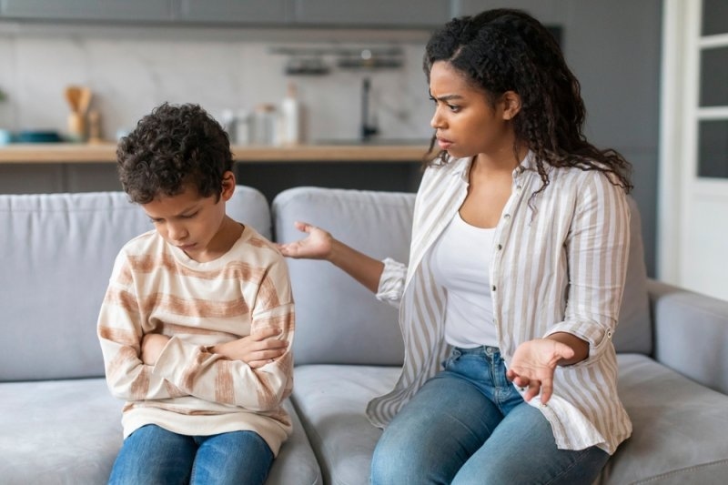  mother scolding upset little son at home