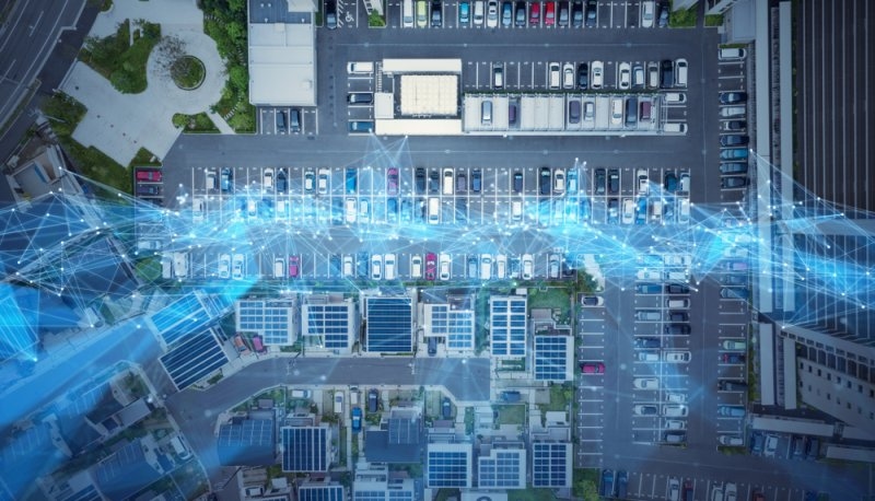 Blue holograms on top of cars indicating smart parking