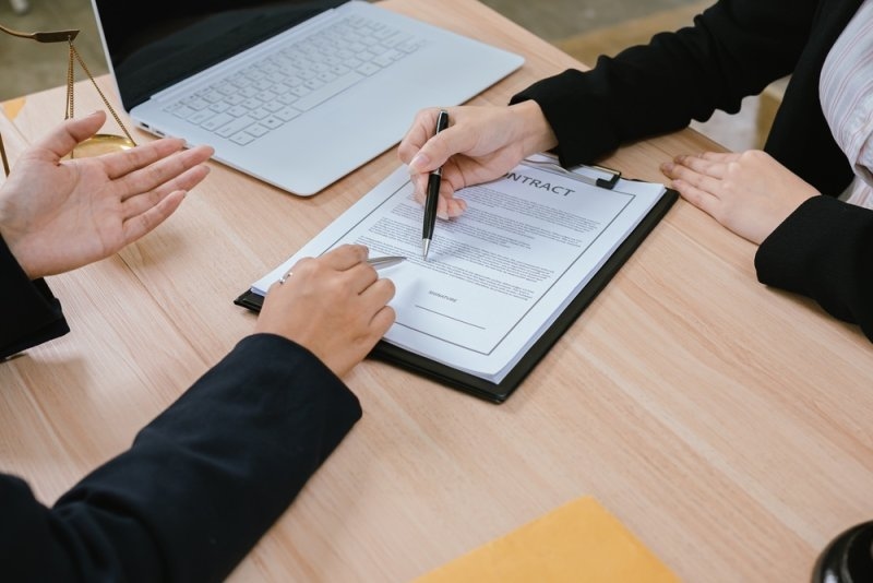 Business partners reviewing contract terms and partnership provisions