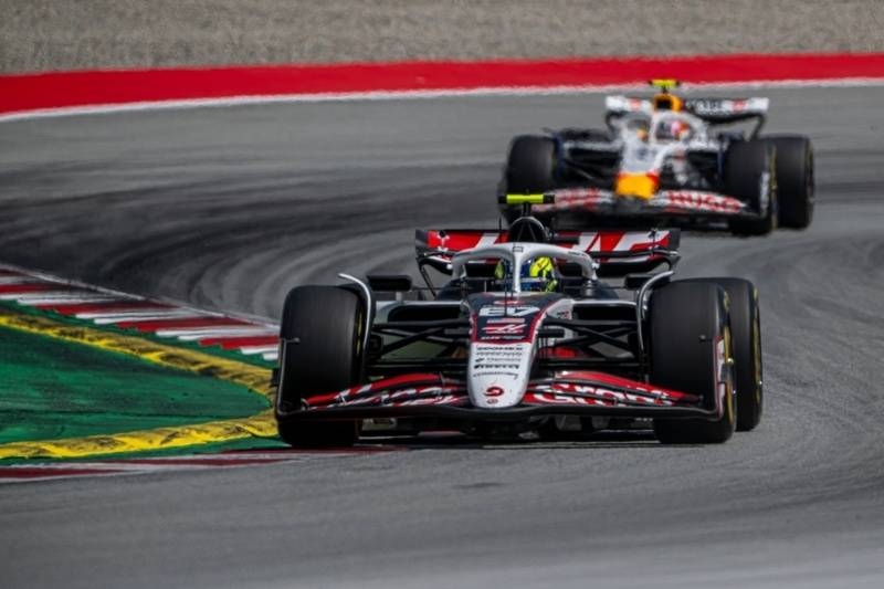 Formula racing cars competing on a racetrack during a high-speed motorsport event.