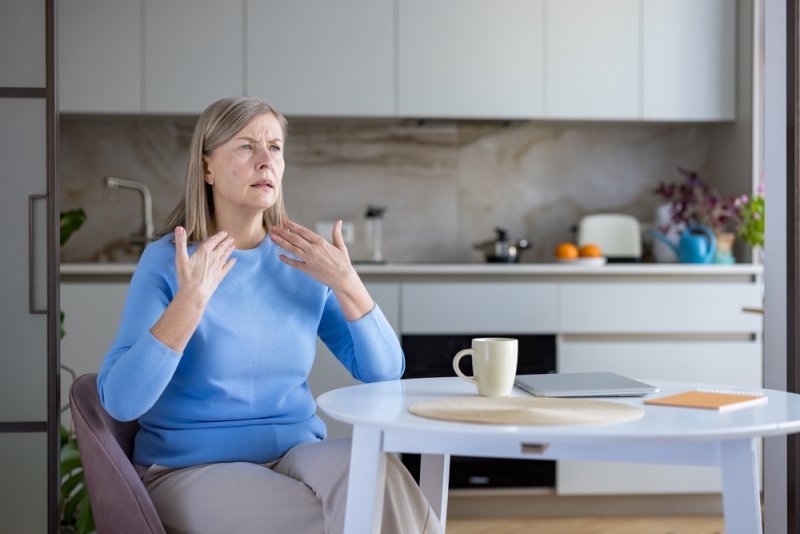 Woman experiencing perimenopause symptoms 