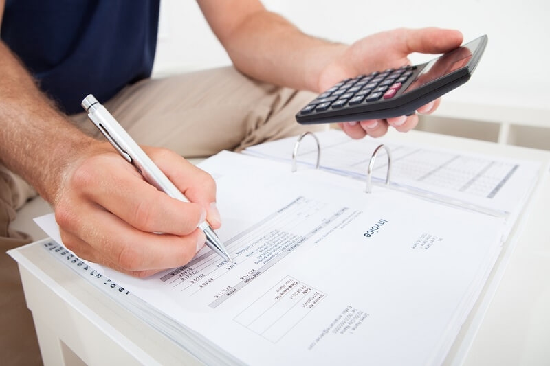 man signing after submitting documents