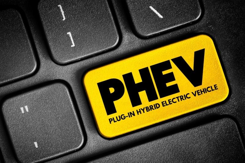 Yellow computer key labeled “PHEV Plug-In Hybrid Electric Vehicle” on a black keyboard.