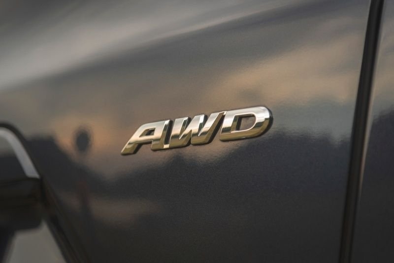 Close-up of an AWD (All-Wheel Drive) badge mounted on a vehicle.