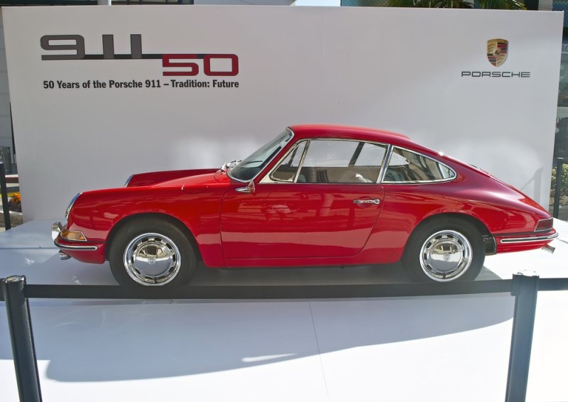 Classic red Porsche 911 displayed at an event celebrating 50 years of the Porsche 911.