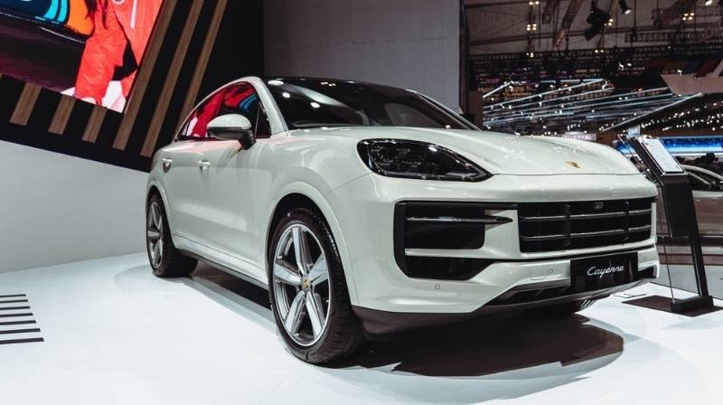 White Porsche Cayenne showcased at an auto exhibition.