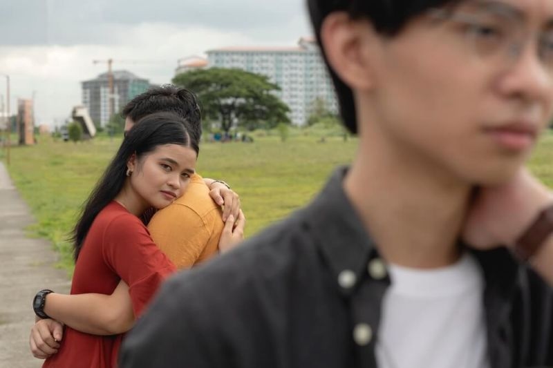 Women hugging her rebound  boyfriend while her ex walks away