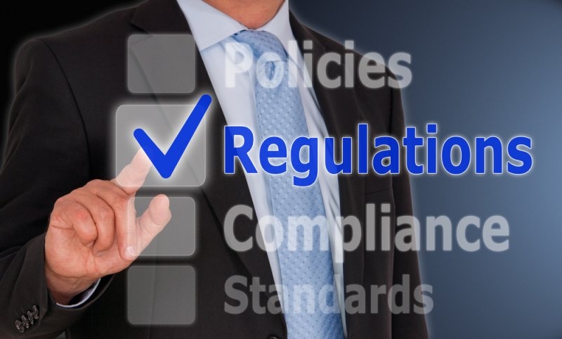 Regulations - Businessman with checkbox