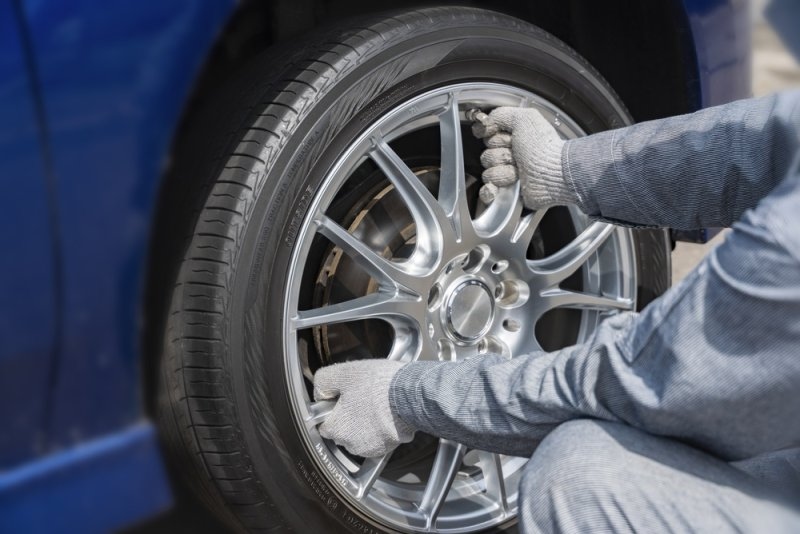 tire mechanic checking a tire for safety purposes