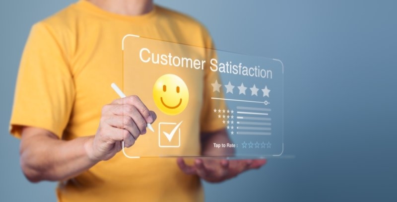 satisfied customer is holding a tablet and giving a positive online review
