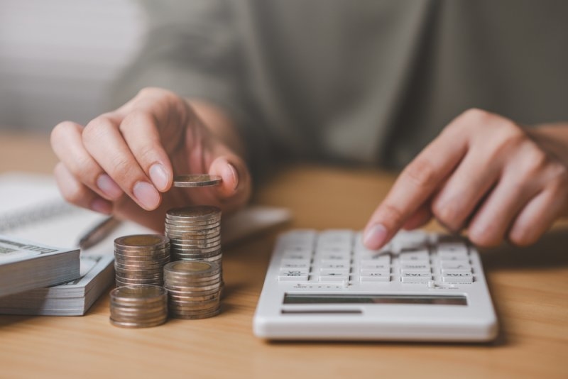man calculating his savings from a discount on car insurance