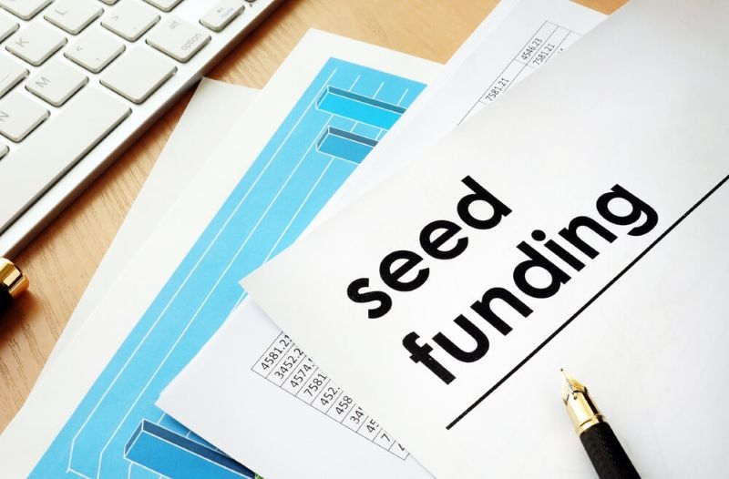 documents named seed funding on a table for a start up
